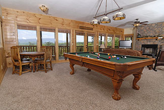 Lower Level area in the cabin that features a livingroom,game room, and a bar
